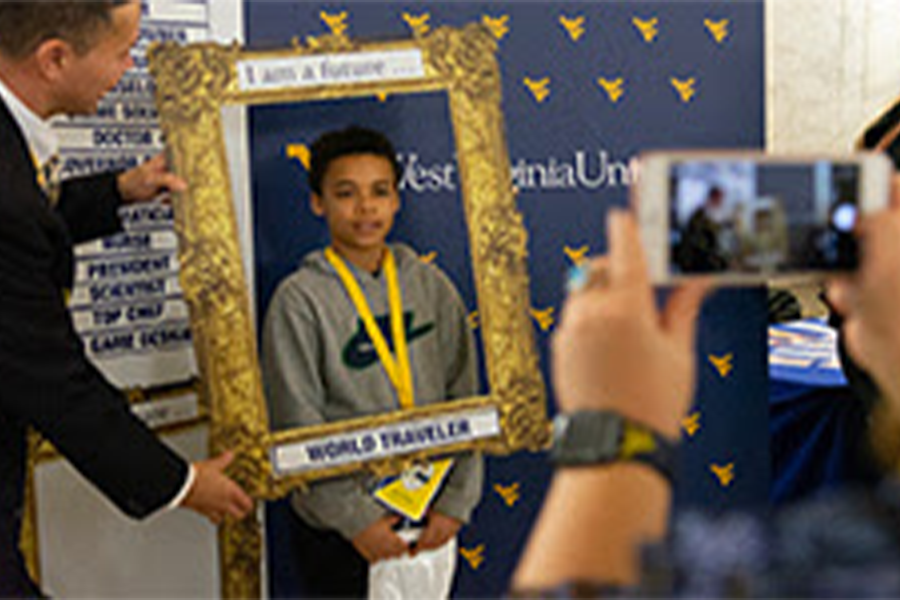 A child participating in a WVU Extension service hosted event during WVU Day