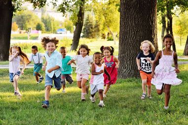 Children running through an open field