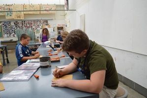 Kids drawing in visual arts academy.